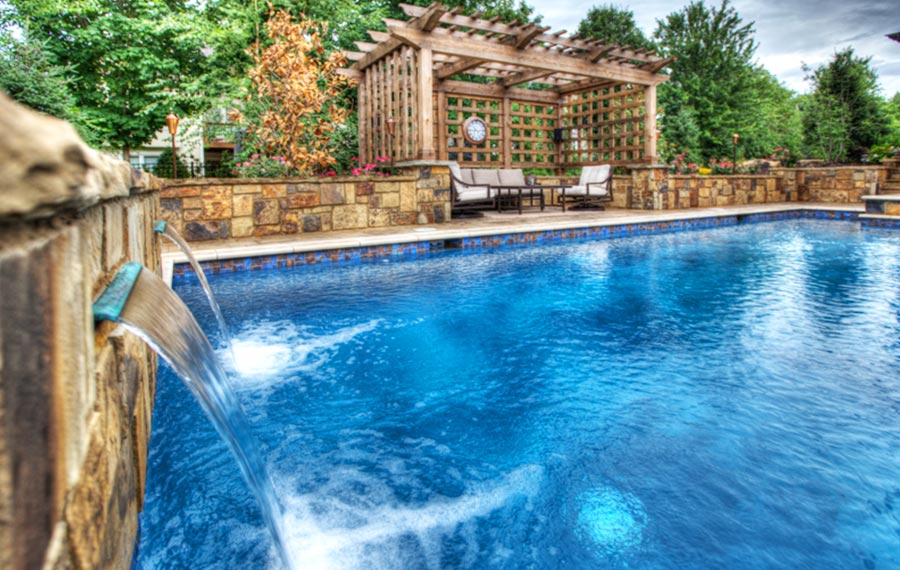 A lap pool and spa in Leawood Kansas by Backyard by Design KC