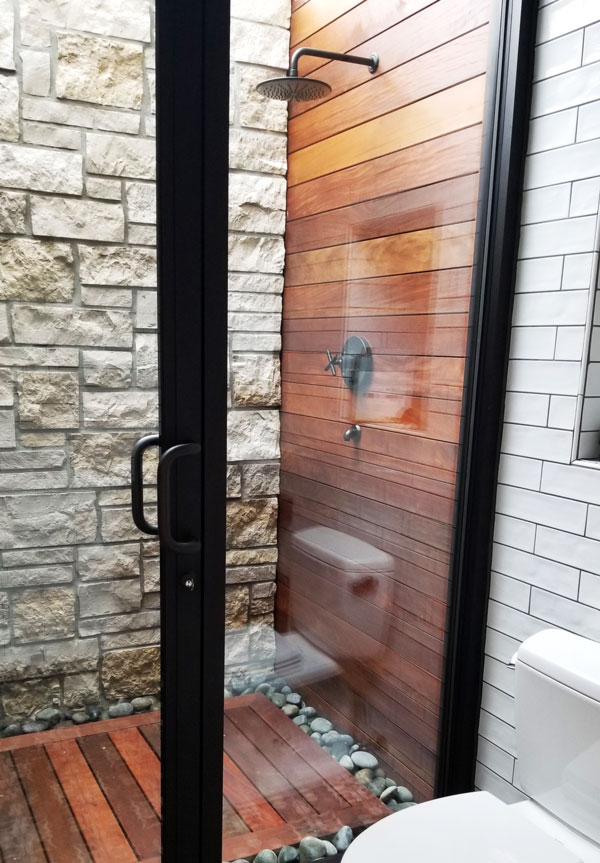 Backyard by design custom outdoor pool house cabana bathroom with an outdoor shower