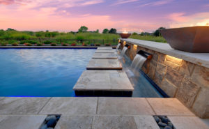 Backyard by design luxurious pool, landscaping and furniture