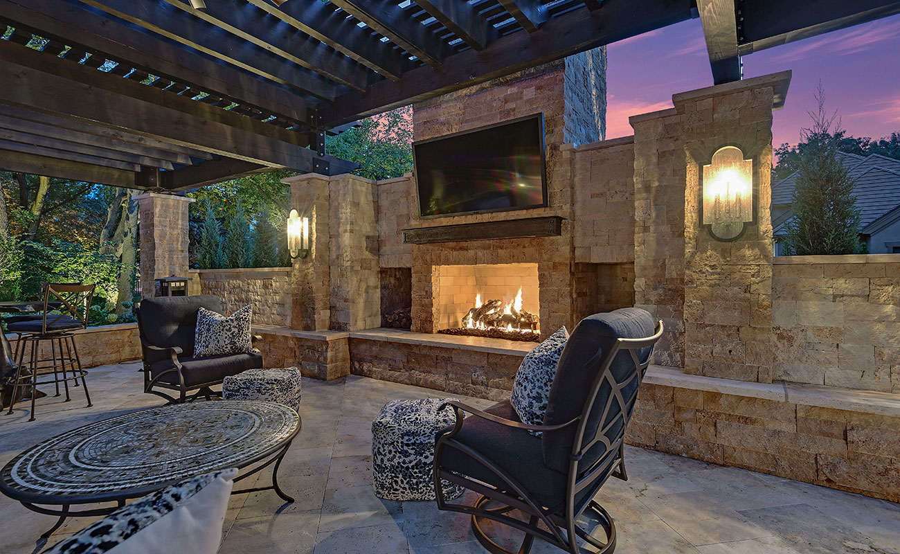 Backyard by design luxurious fireplace, landscaping and furniture