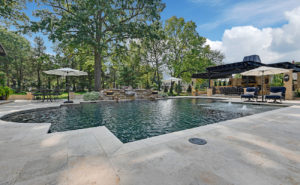 Backyard by design luxurious pool, landscaping and furniture
