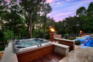 Backyard hot tub with fireplace, pool, landscaping and fruniture